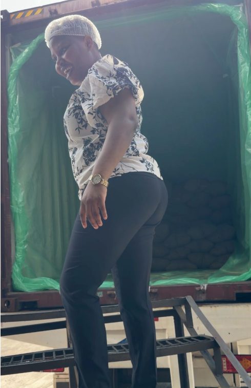 Oluwaseun Lijoka in a hairnet at the open door of a lined container during loading